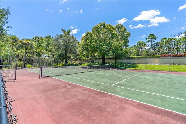 an empty room with a window and ceiling fan