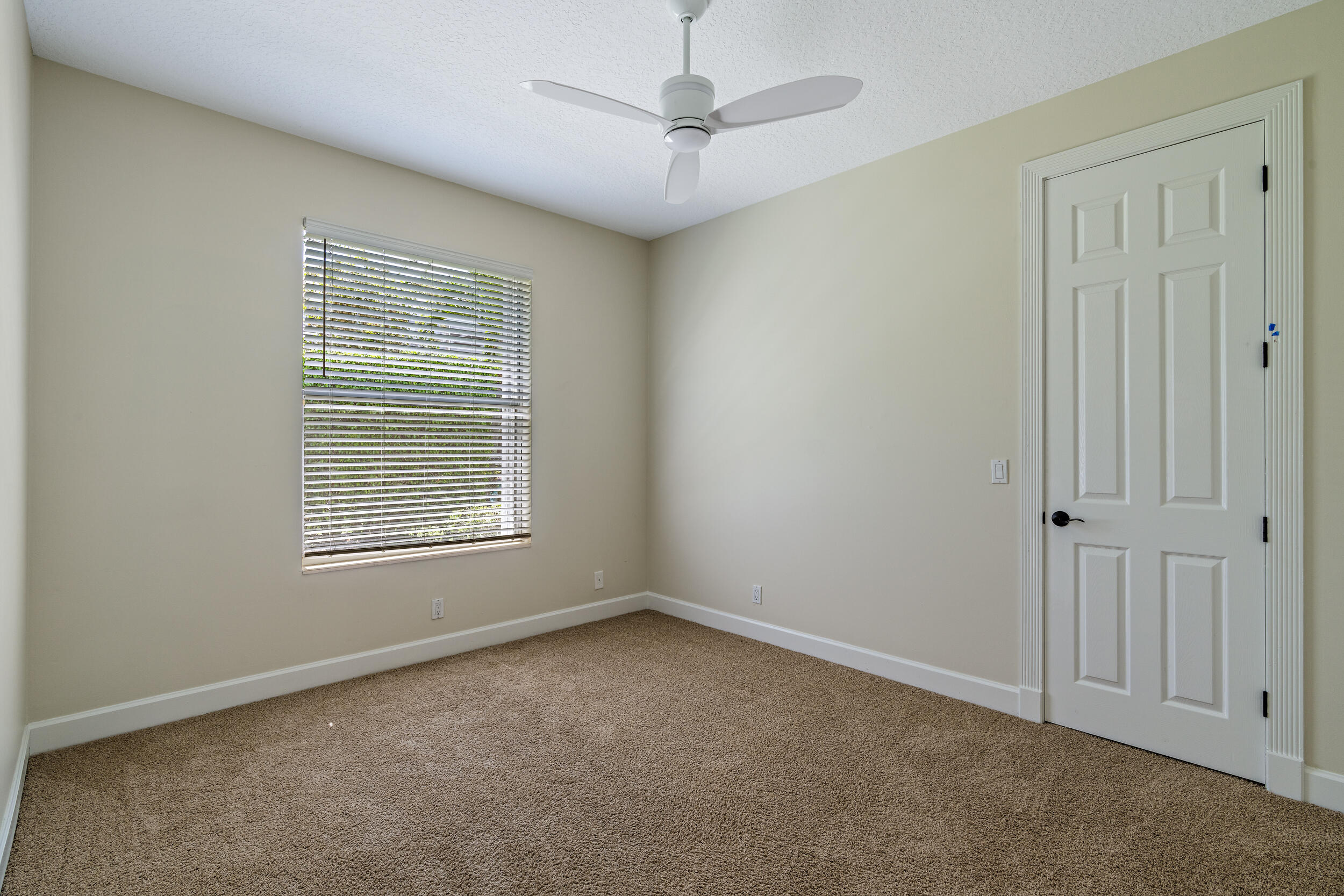 19866 Loxahatchee Pointe Drive Jupiter, FL 33458 - Photo 34 of 43 an empty room with windows and fan