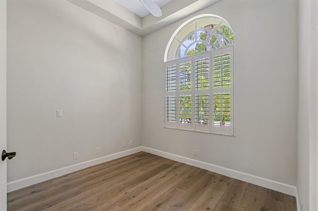a kitchen view with a sink and glass window
