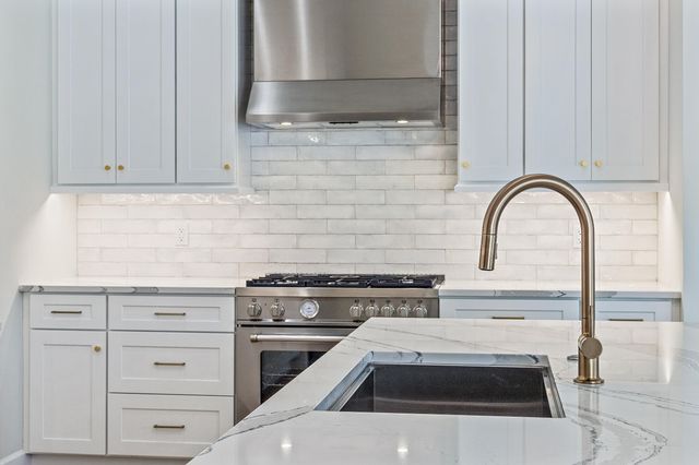 a house with lots of trees in front of it