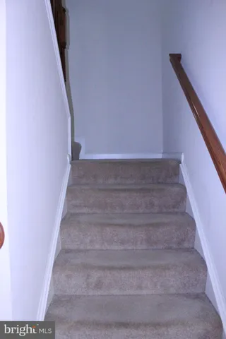 a view of staircase with white walls