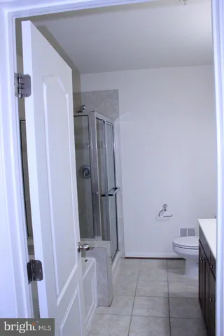 a bathroom with a shower and a toilet