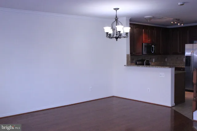 a view of a kitchen with a microwave and a table