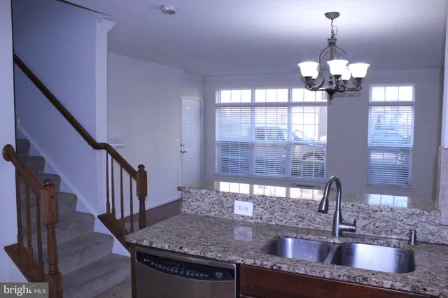 a kitchen with granite countertop a sink and a window