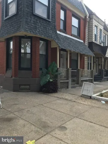 a view of a brick house with many windows