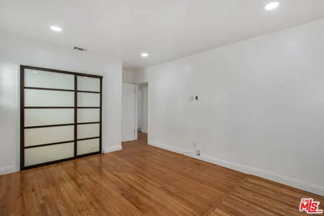 a view of a room with wooden floor