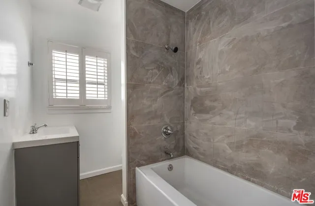 a bathroom with a bathtub and a sink