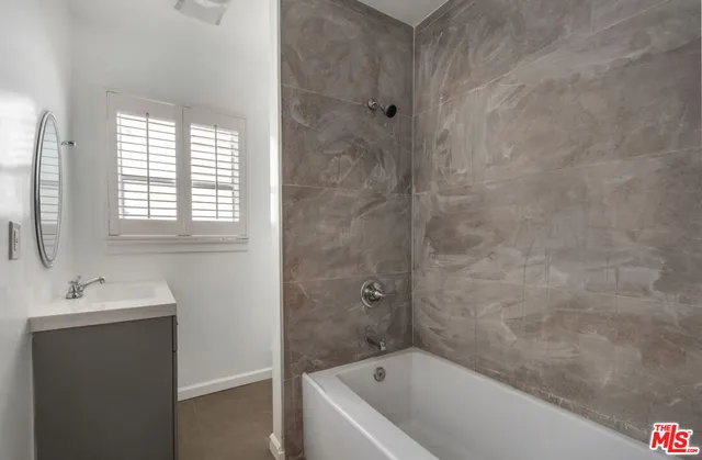 a bathroom with a bathtub and a sink