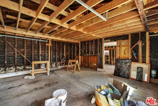 a view of a room with wooden floor and furniture
