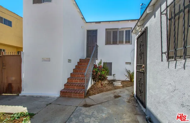 a view of a porch with wooden floor and a stairs
