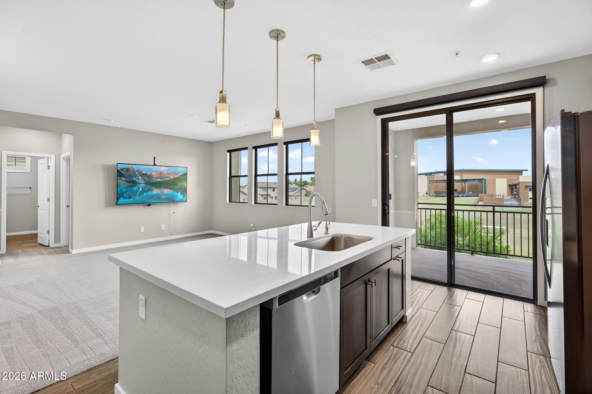 3900 East Baseline Road, Unit 149 Phoenix, AZ 85042 - Photo 11 of 54 a view of a kitchen with a sink and wooden floor