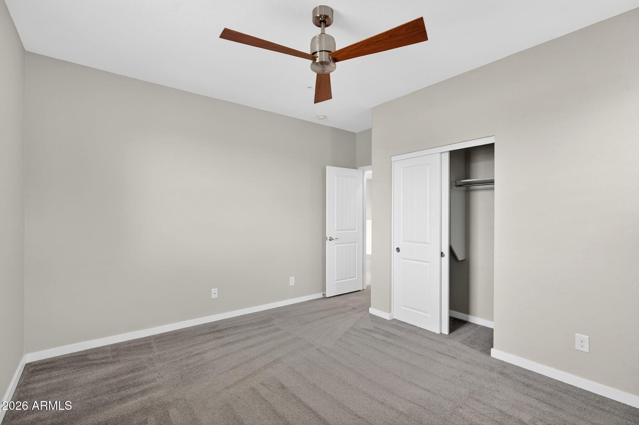 3900 East Baseline Road, Unit 149 Phoenix, AZ 85042 - Photo 25 of 54 a view of a room with wooden floor and a ceiling fan