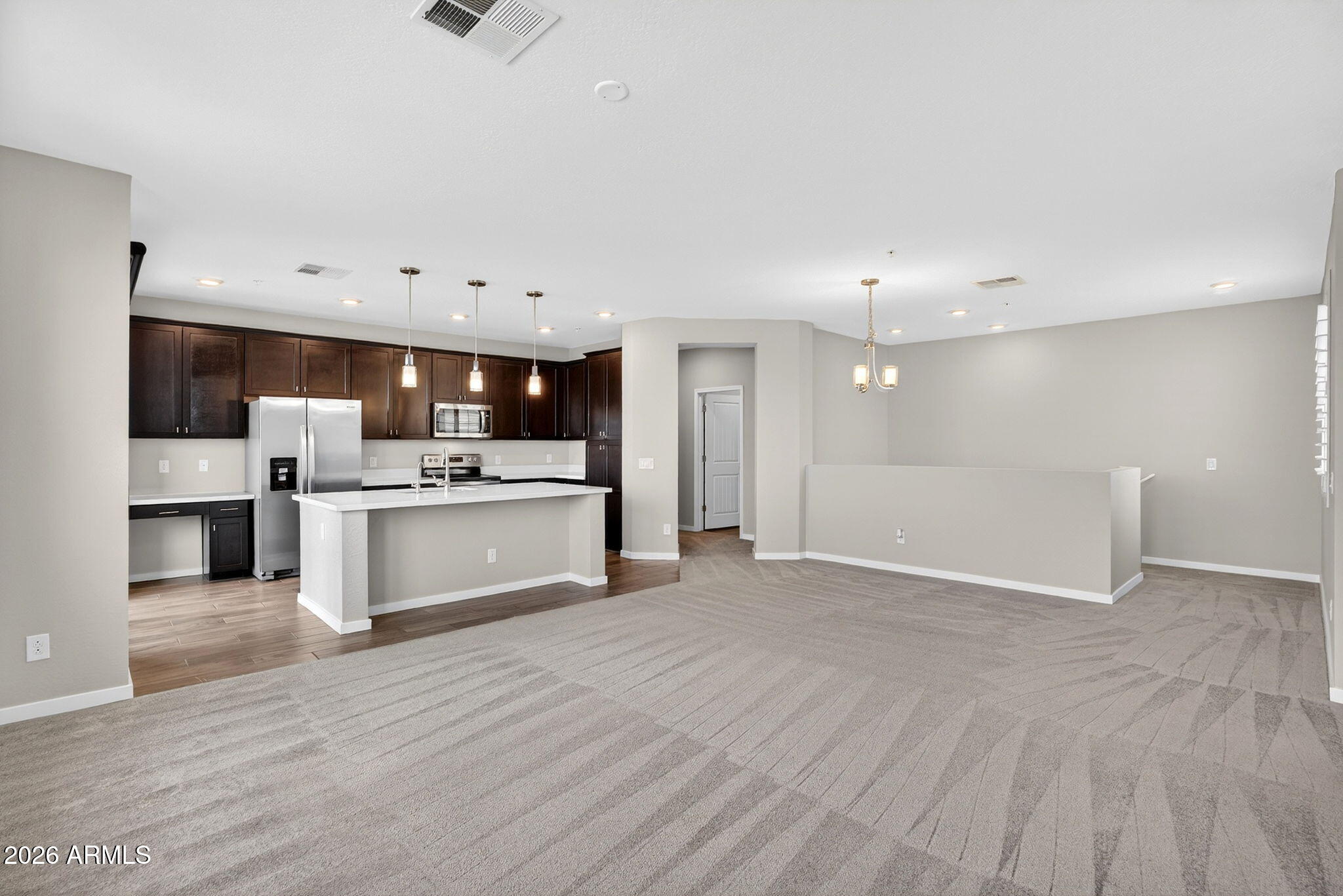 3900 East Baseline Road, Unit 149 Phoenix, AZ 85042 - Photo 2 of 54 a large white kitchen with kitchen island a sink dishwasher and a stove with wooden floor