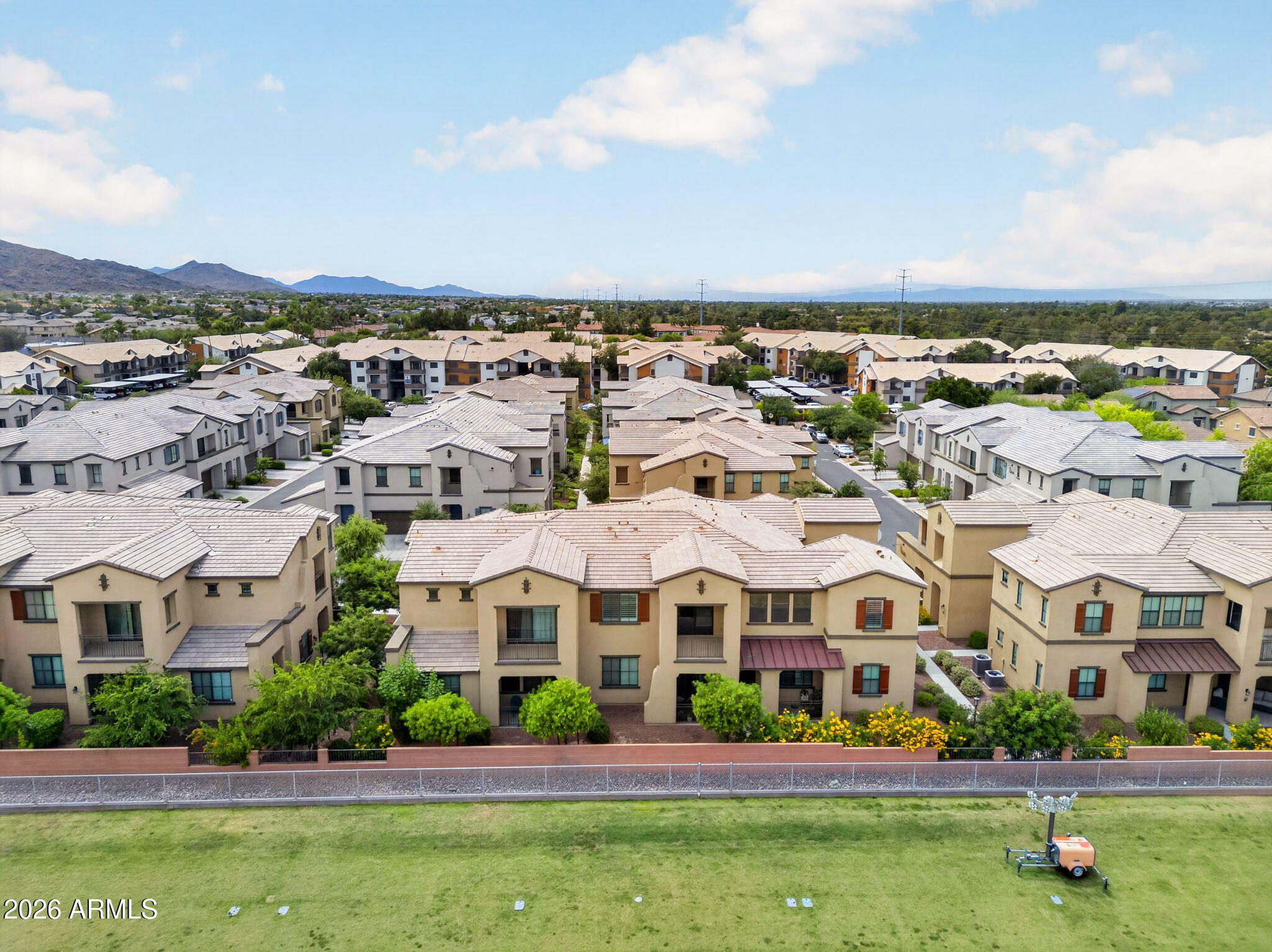3900 East Baseline Road, Unit 149 Phoenix, AZ 85042 - Photo 45 of 54 an aerial view of residential houses with yard and mountain view in back
