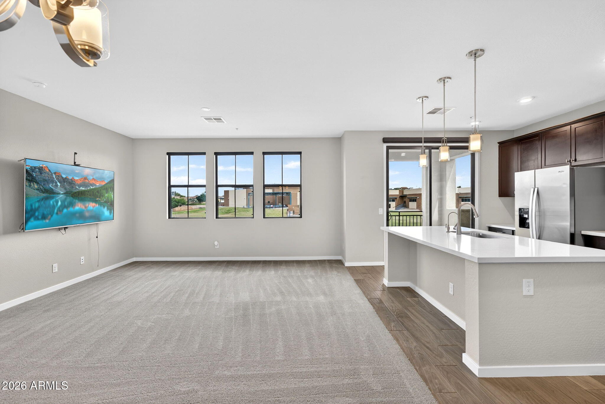 3900 East Baseline Road, Unit 149 Phoenix, AZ 85042 - Photo 6 of 54 a view of kitchen with kitchen island wooden floor center island and stainless steel appliances
