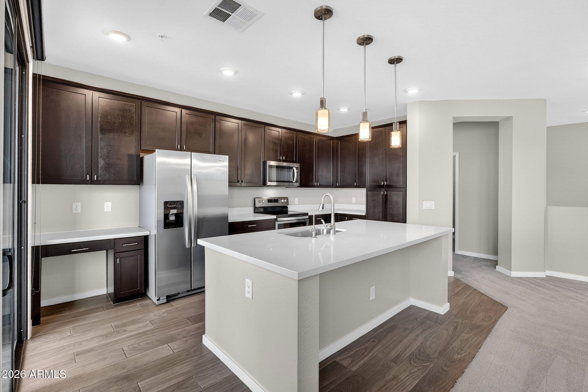 3900 East Baseline Road, Unit 149 Phoenix, AZ 85042 - Photo 8 of 54 a large kitchen with stainless steel appliances kitchen island a large island in the center