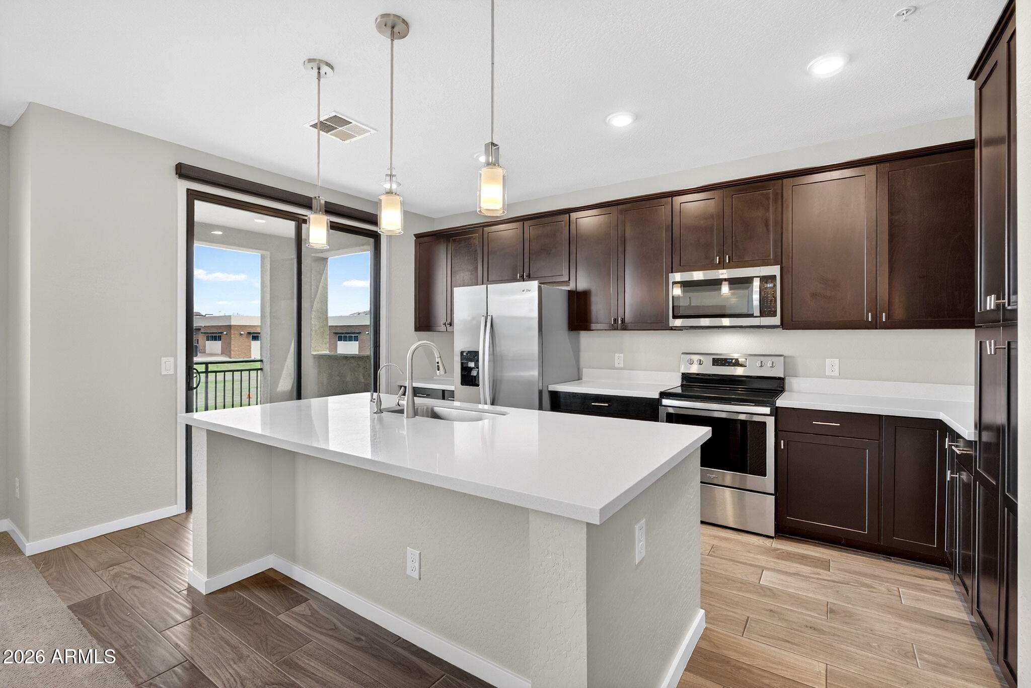 3900 East Baseline Road, Unit 149 Phoenix, AZ 85042 - Photo 9 of 54 a kitchen with kitchen island a sink stainless steel appliances and cabinets