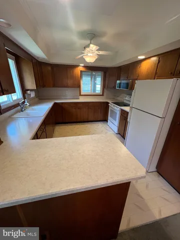 a kitchen with stainless steel appliances a stove a refrigerator a sink and a refrigerator