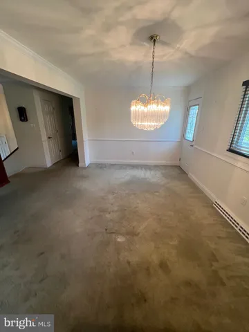 a view of a room with window and a ceiling fan