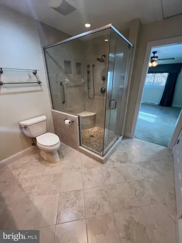 a bathroom with a toilet and a shower