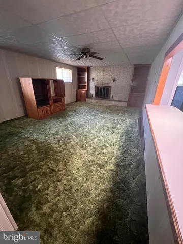 a view of a livingroom with furniture and staircase