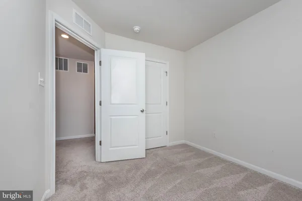 a view of an empty room with stairs