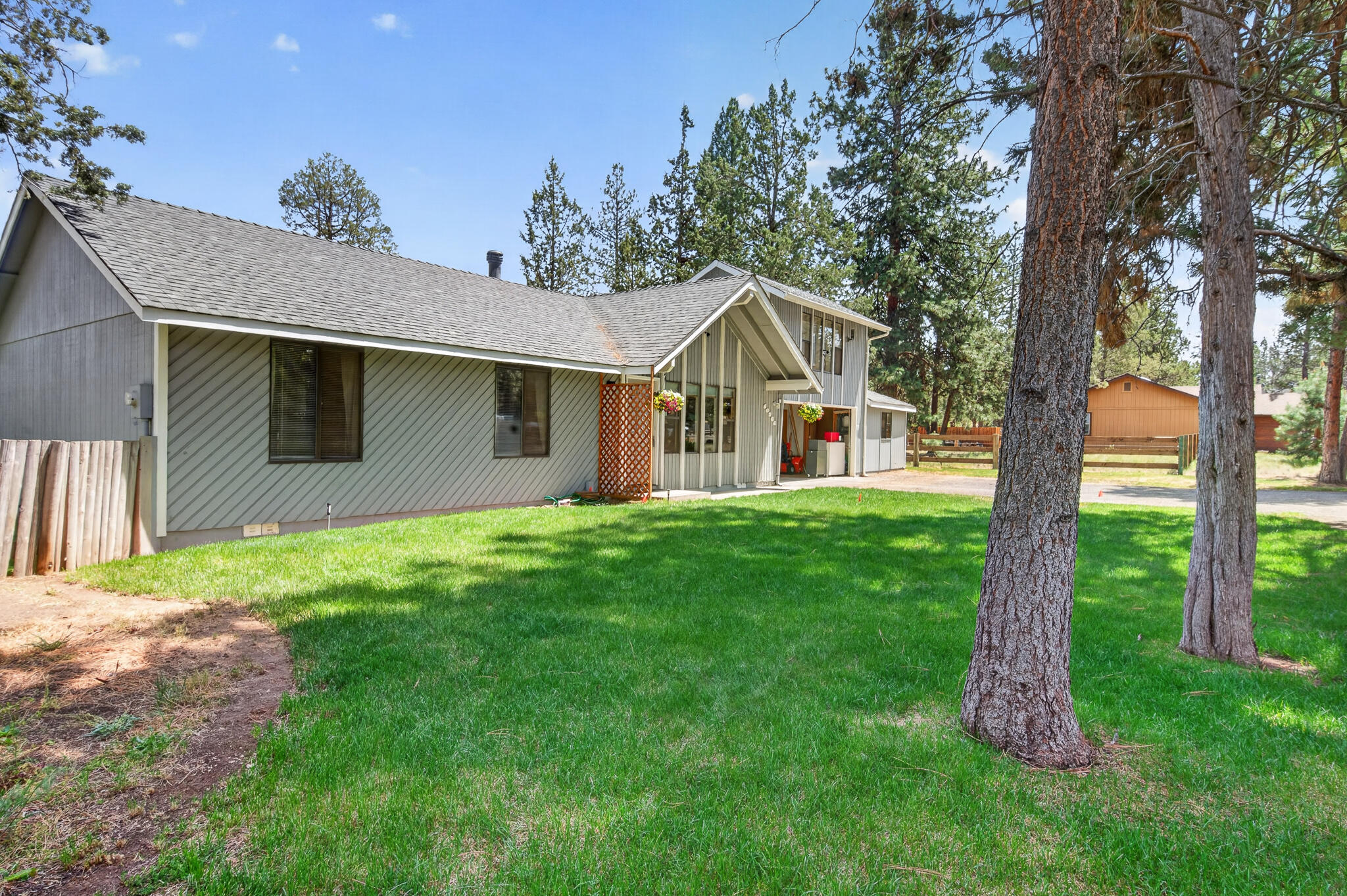 60866 Brosterhous Road Bend, OR 97702 - Photo 6 of 41 a front view of a house with a garden