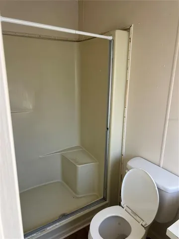 a white toilet sitting next to a bathroom sink