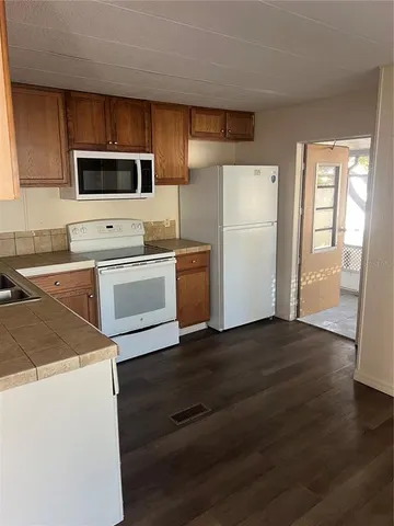 a kitchen with wooden cabinets and stainless steel appliances