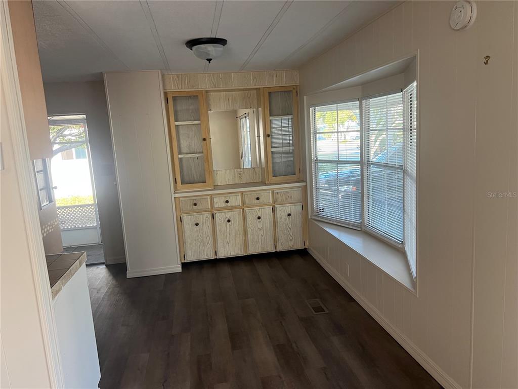 1610 Reynolds Road, Unit 87 Lakeland, FL 33801 - Photo 5 of 12 a view of an empty room with wooden floor and a window