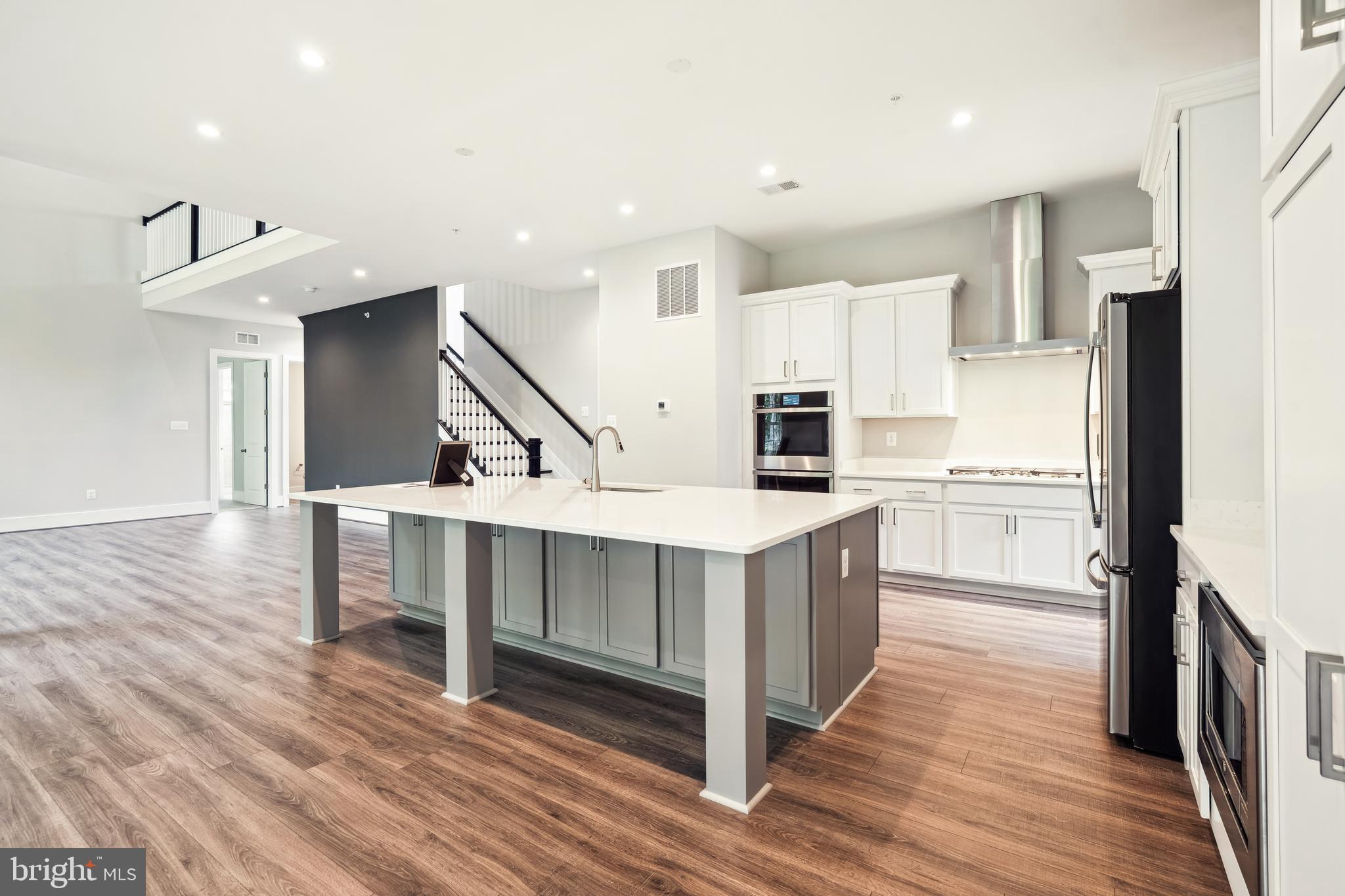 3906 Diplomat Avenue Bowie, MD 20721 - Photo 13 of 47 a kitchen with white cabinets and stainless steel appliances