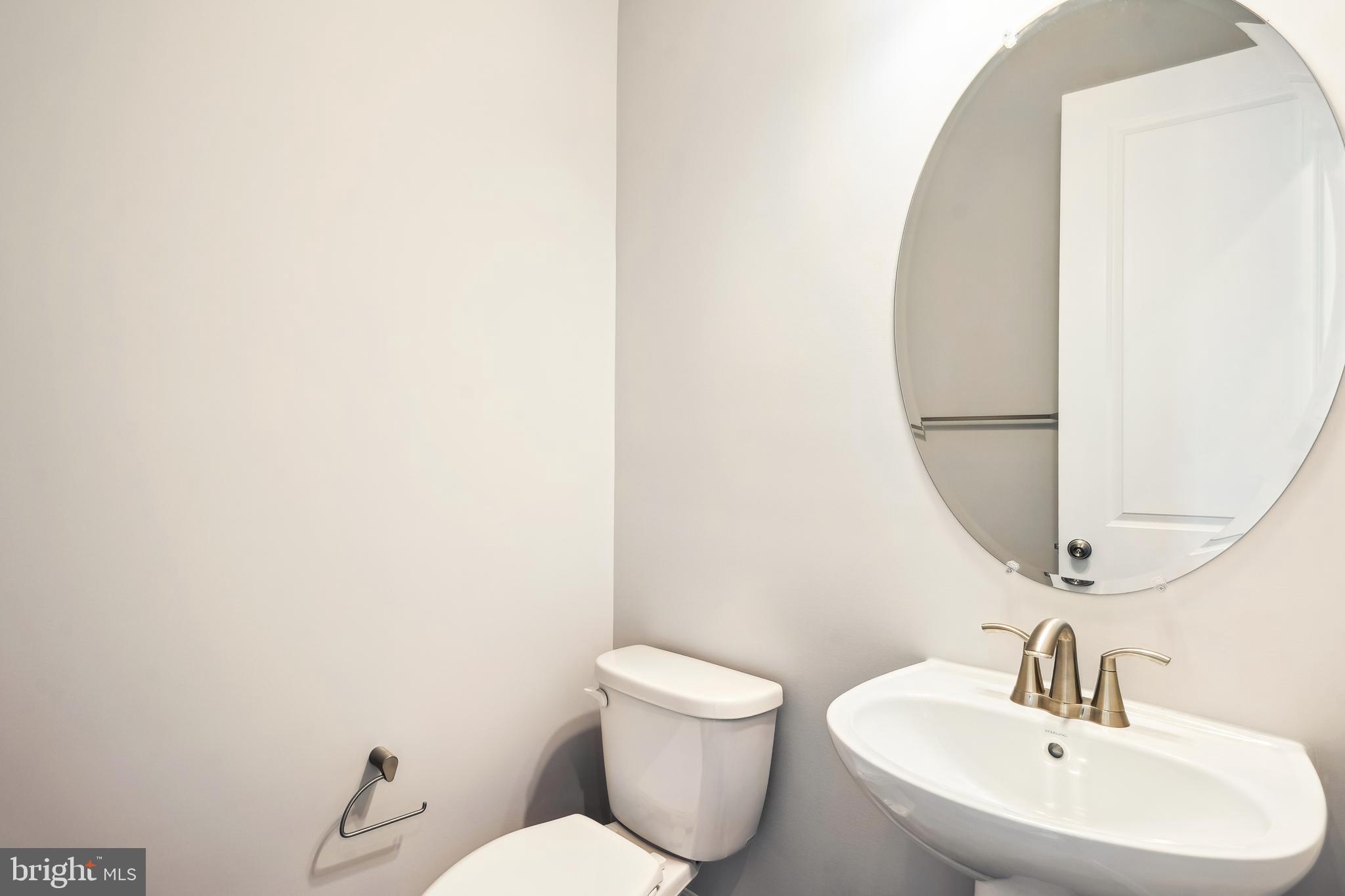 3906 Diplomat Avenue Bowie, MD 20721 - Photo 18 of 47 a bathroom with a toilet a sink and mirror