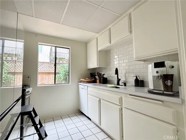 a kitchen with sink cabinets and window