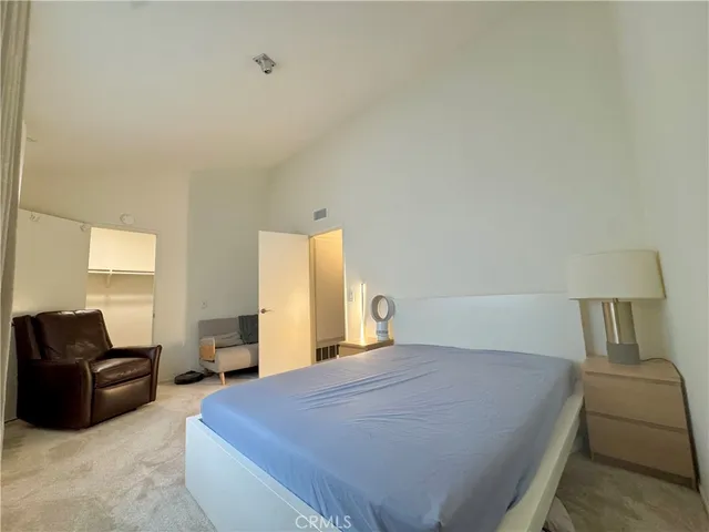 a bedroom with a bed and couch