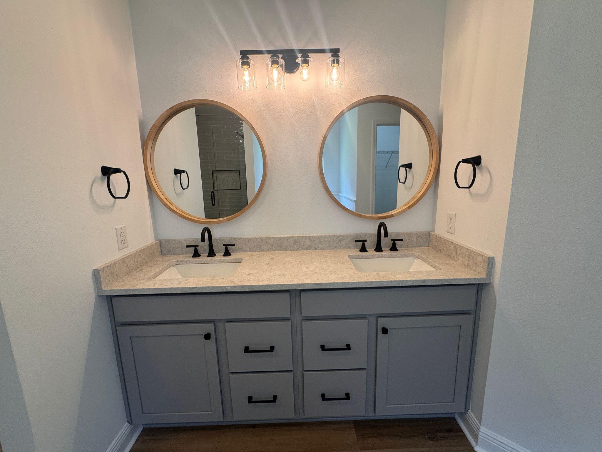 516 Vulpes Sanctuary Loop Crestview, FL 32536 - Photo 13 of 30 a bathroom with a double vanity sink and a mirror