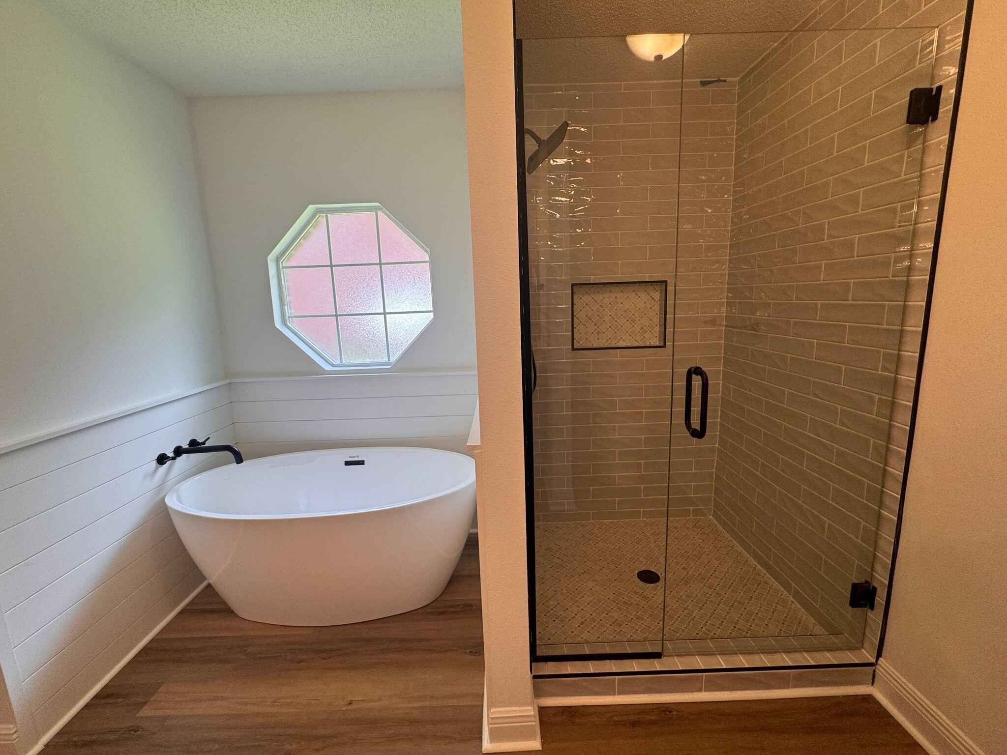 516 Vulpes Sanctuary Loop Crestview, FL 32536 - Photo 14 of 30 a bathroom with a bathtub and shower