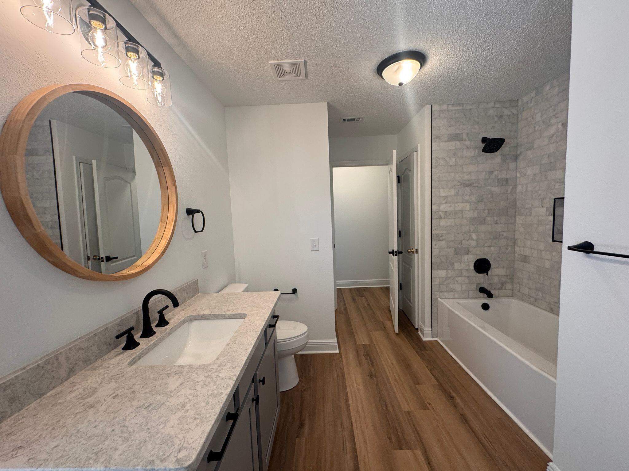 516 Vulpes Sanctuary Loop Crestview, FL 32536 - Photo 17 of 30 a bathroom with a sink a toilet and a tub