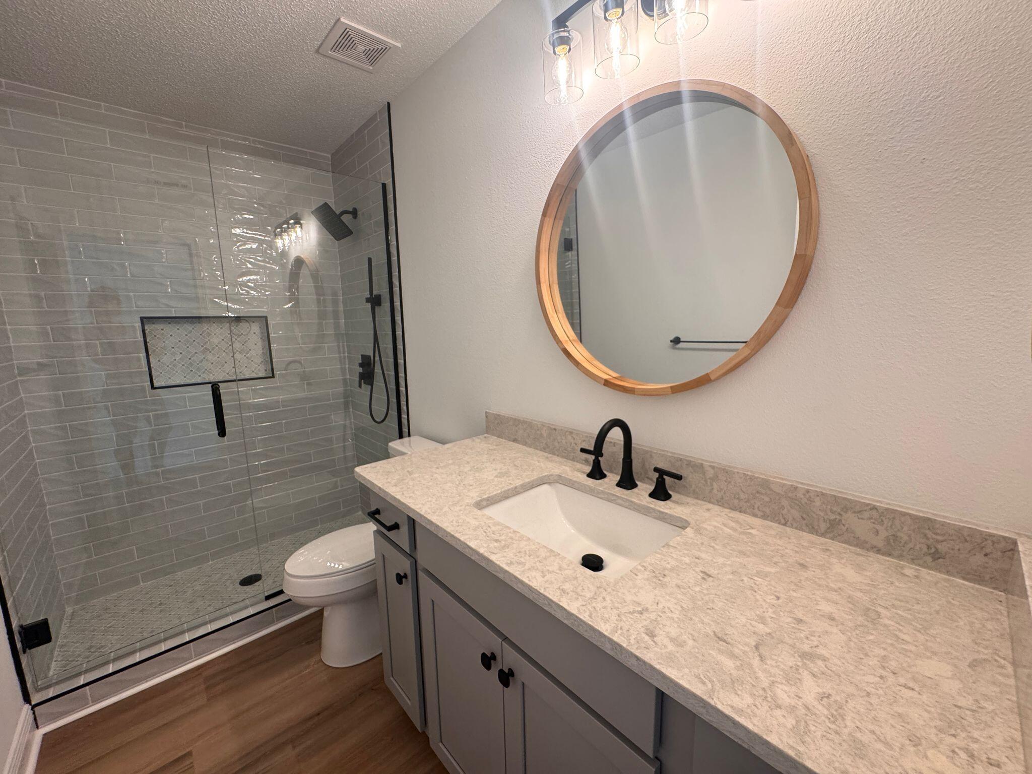516 Vulpes Sanctuary Loop Crestview, FL 32536 - Photo 23 of 30 a bathroom with a sink a toilet and shower