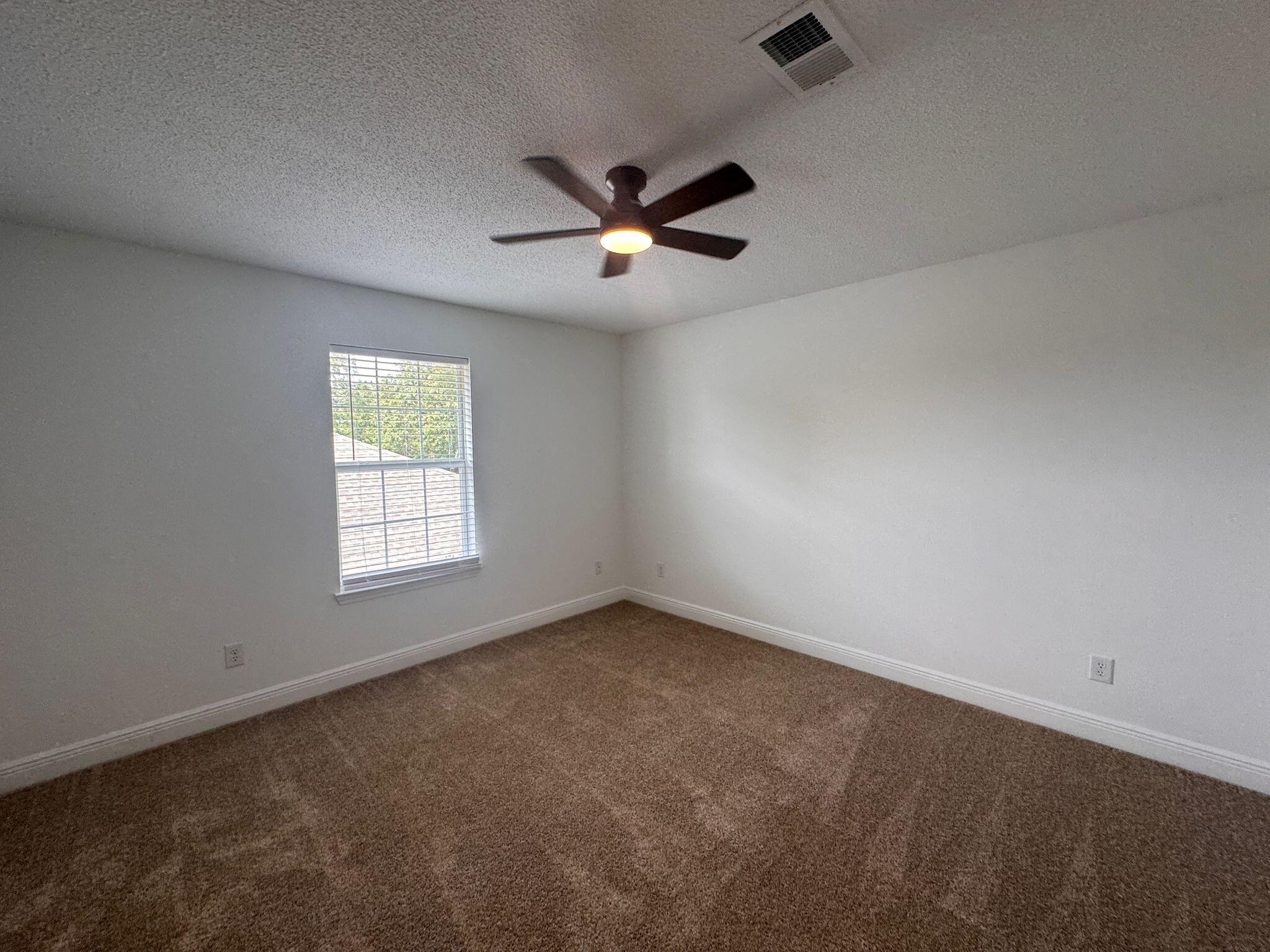516 Vulpes Sanctuary Loop Crestview, FL 32536 - Photo 24 of 30 an empty room with a window and ceiling fan