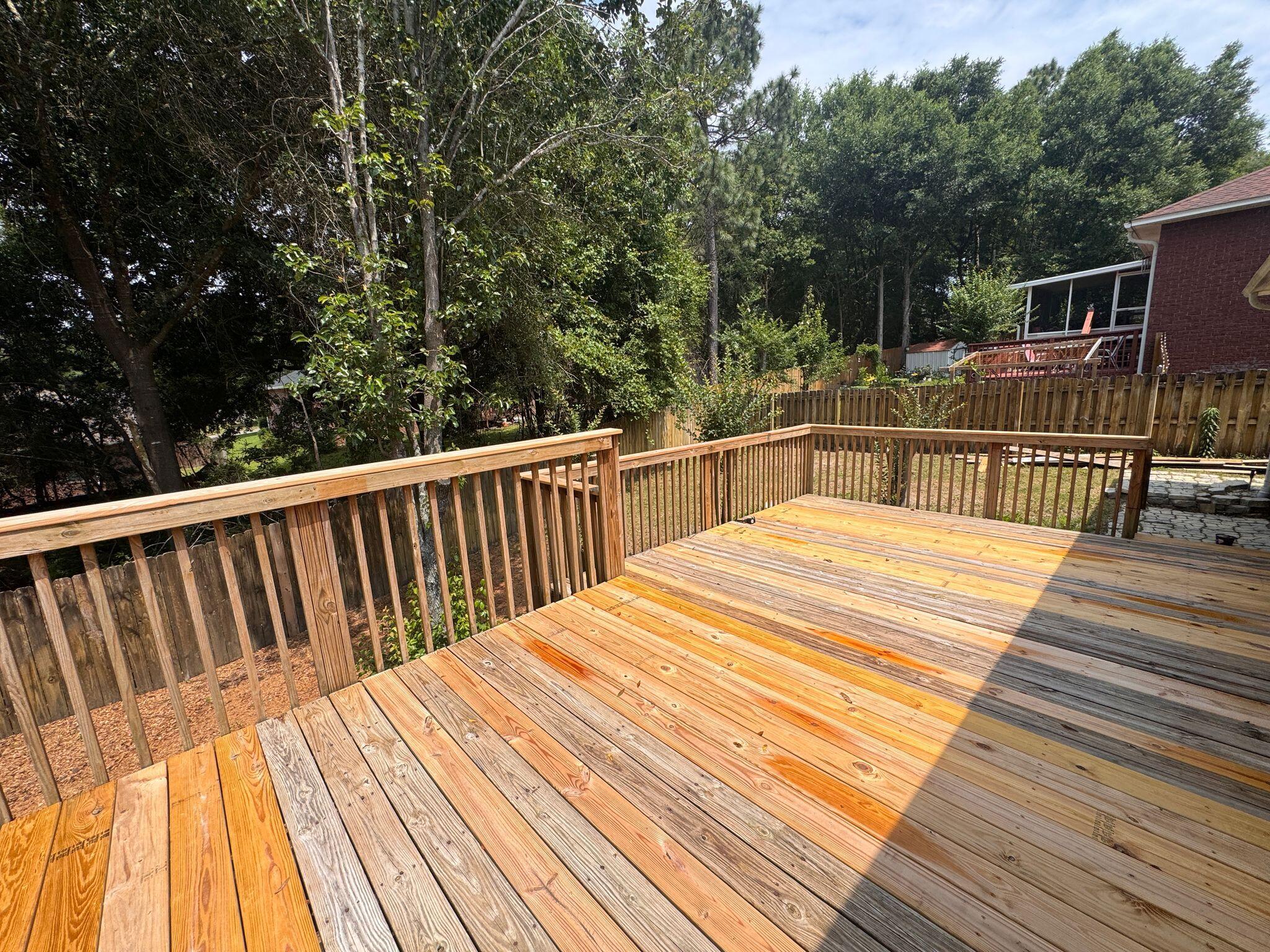 516 Vulpes Sanctuary Loop Crestview, FL 32536 - Photo 26 of 30 a view of balcony with wooden floor and fence