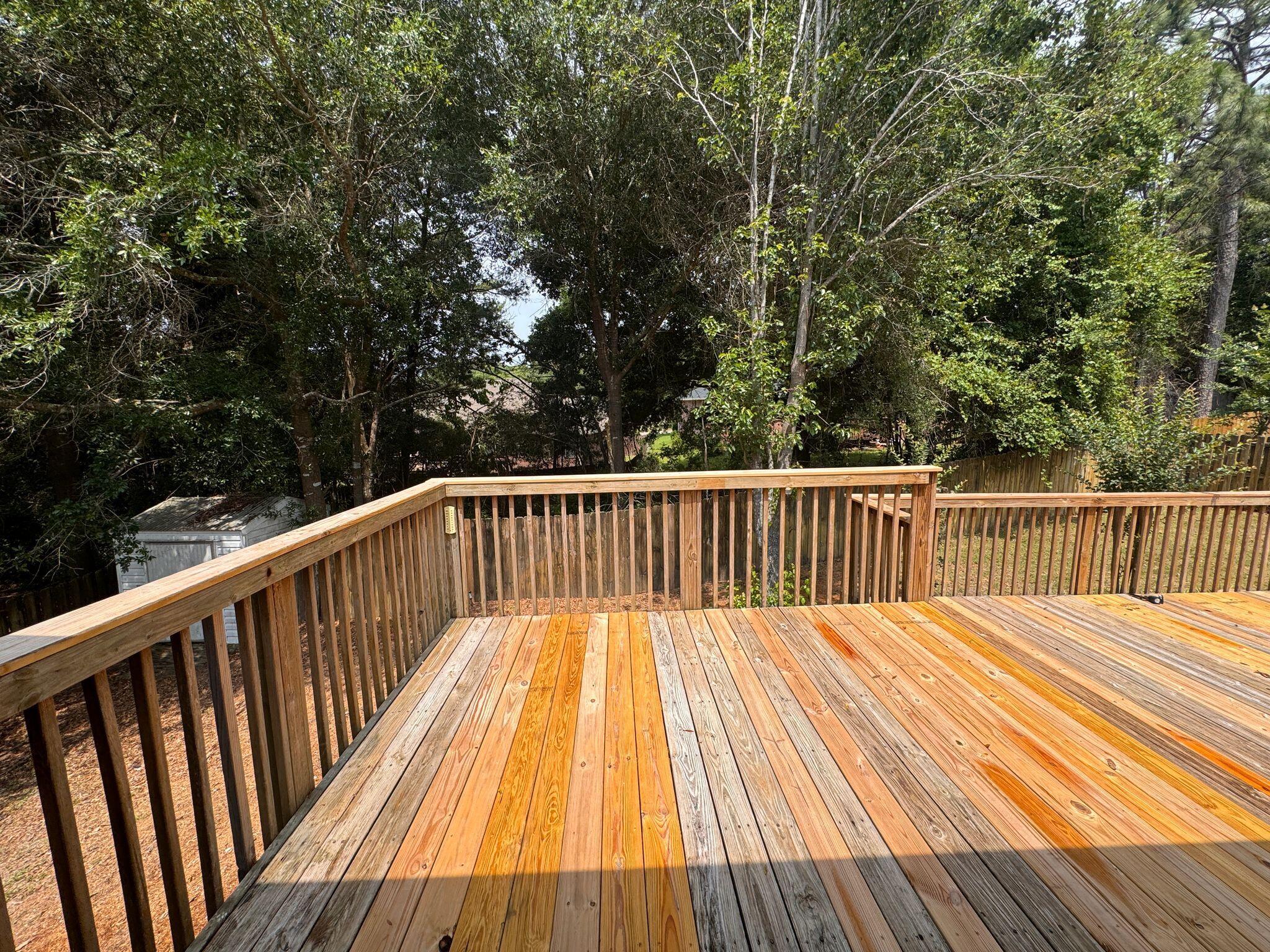 516 Vulpes Sanctuary Loop Crestview, FL 32536 - Photo 27 of 30 a balcony with wooden floor and trees