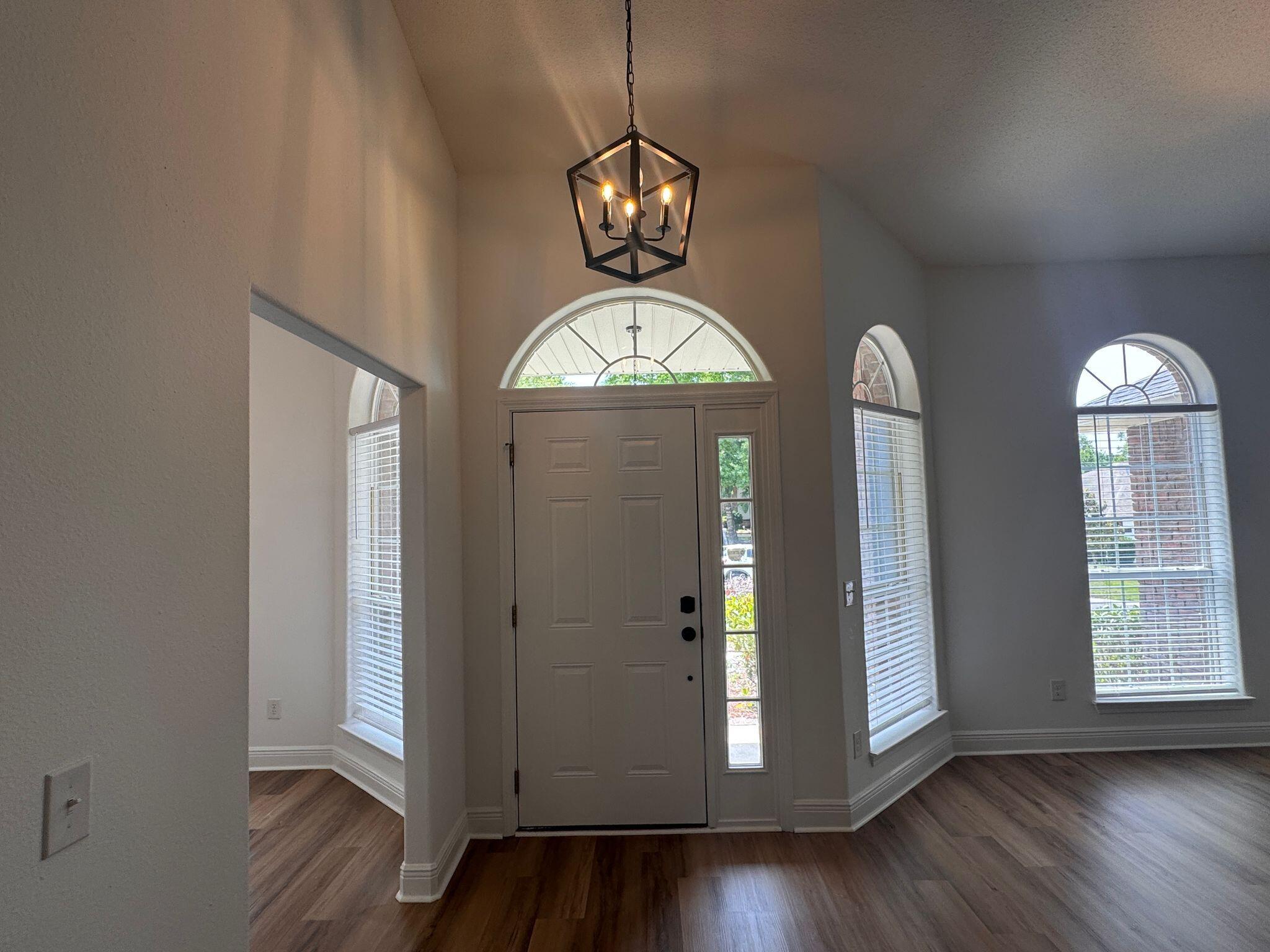 516 Vulpes Sanctuary Loop Crestview, FL 32536 - Photo 3 of 30 a view of a livingroom with wooden floor and windows