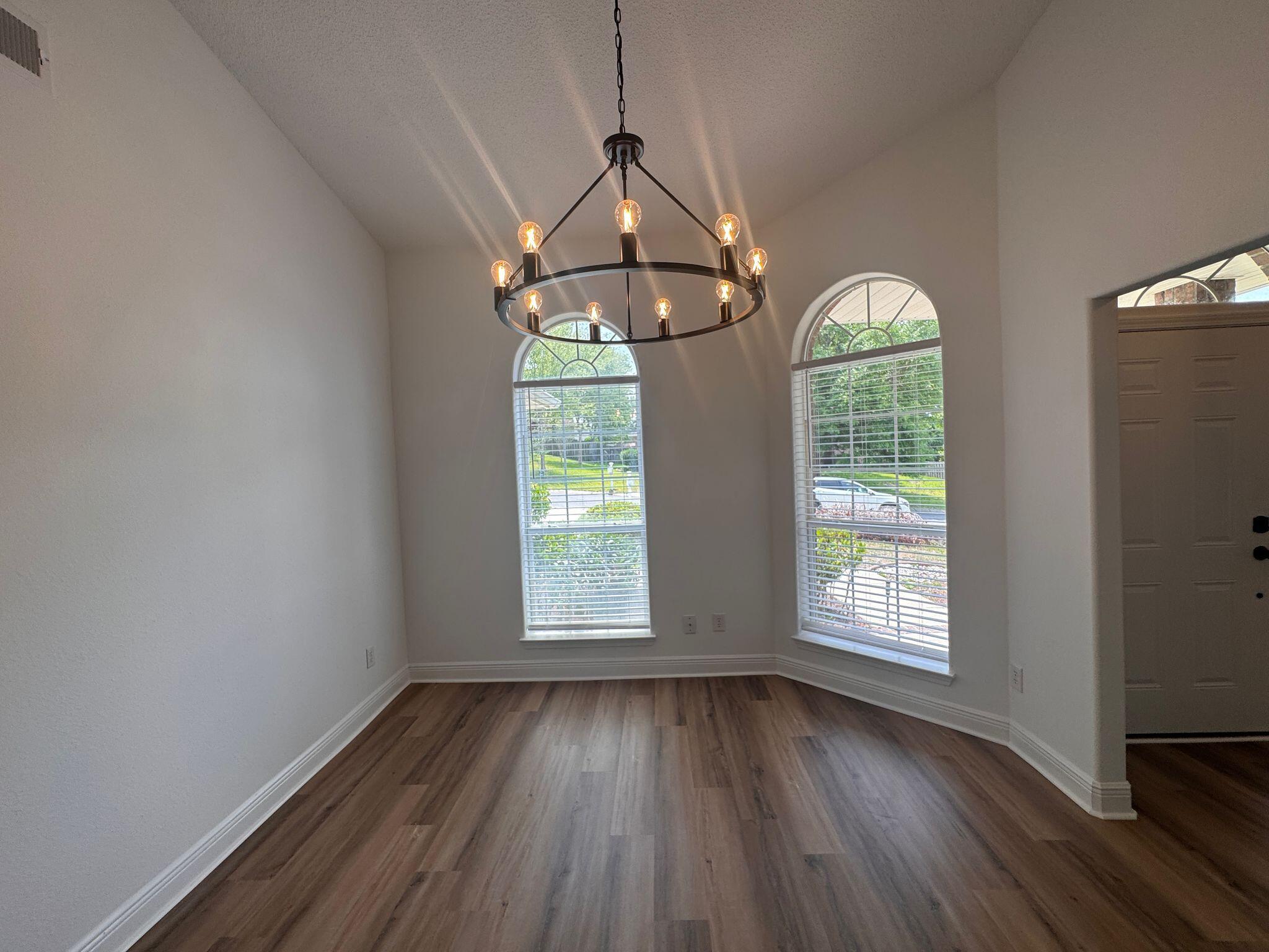 516 Vulpes Sanctuary Loop Crestview, FL 32536 - Photo 4 of 30 an empty room with wooden floor fan and windows