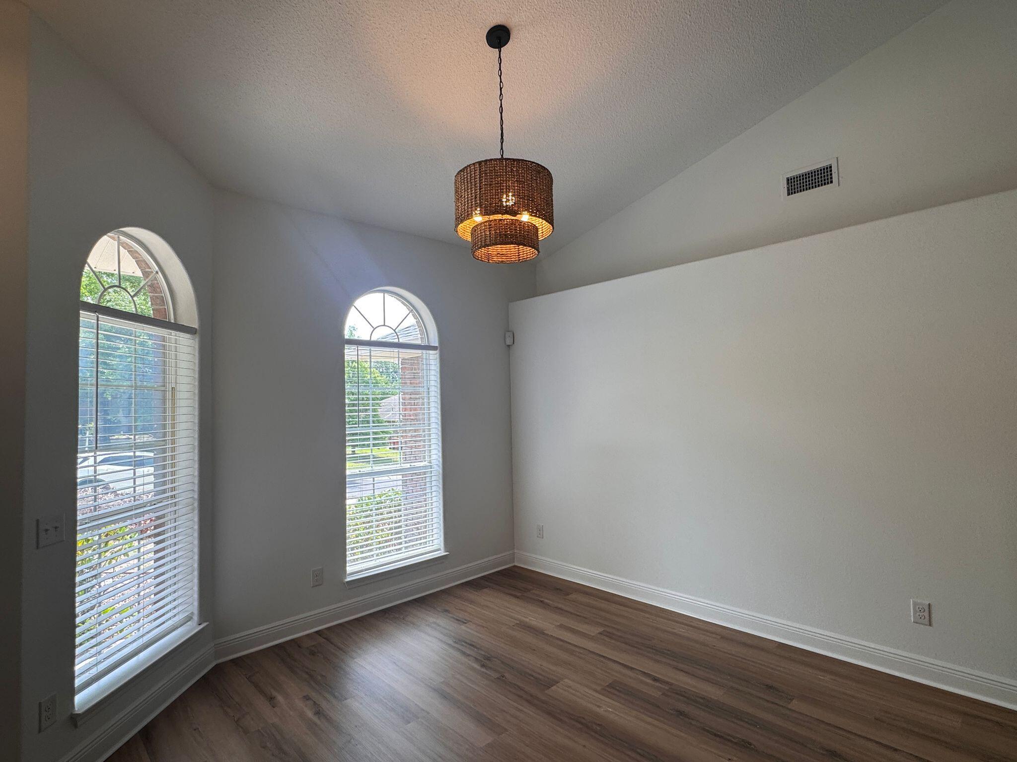 516 Vulpes Sanctuary Loop Crestview, FL 32536 - Photo 7 of 30 a room with wooden floor chandelier and windows
