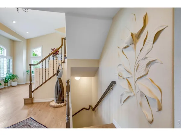 a living room with stainless steel appliances kitchen island granite countertop a couch and a view of kitchen