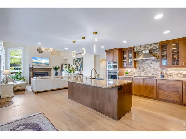 a kitchen with kitchen island granite countertop a large counter top and stainless steel appliances