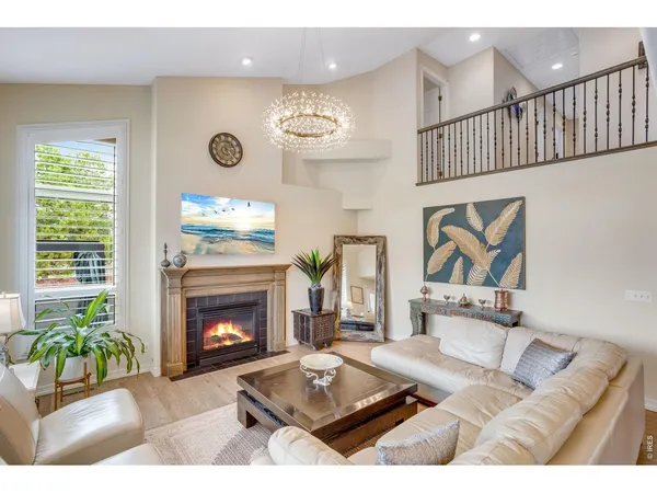 a living room with furniture a chandelier and a dining table