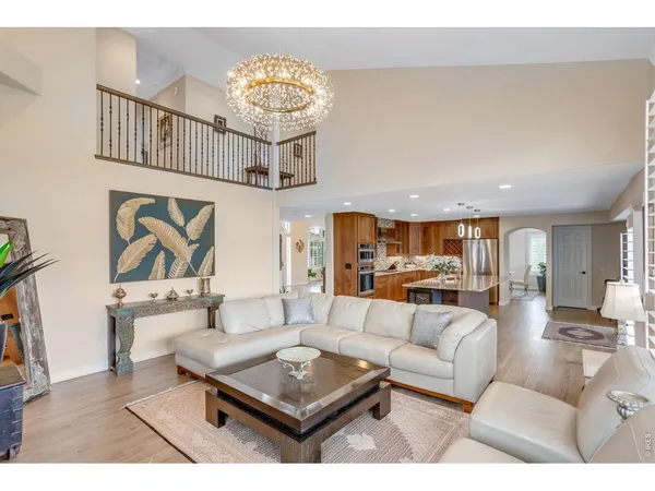 a view of a dining room with furniture a chandelier and a window