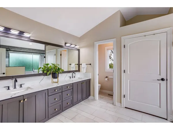 a bathroom with a glass shower door