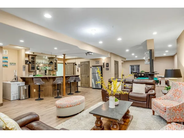 a kitchen with granite countertop a table and chairs in it